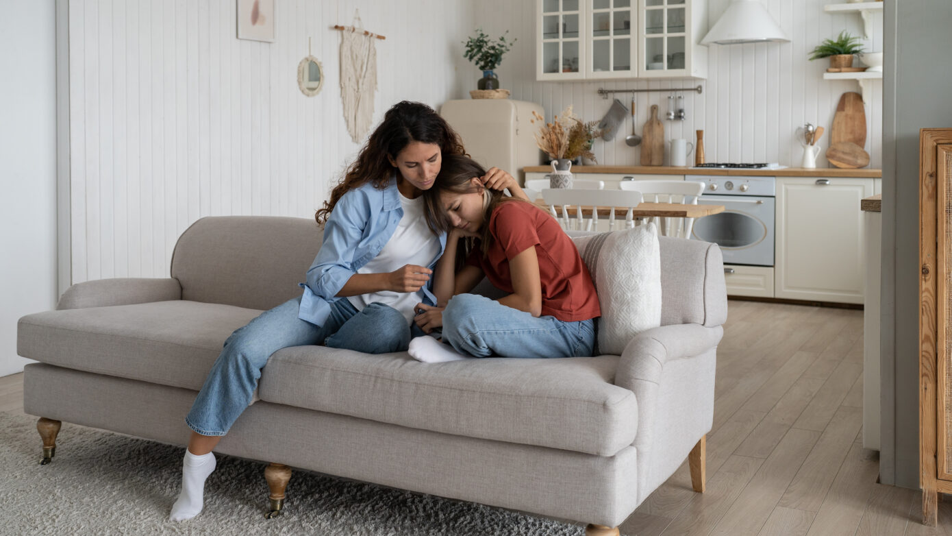 Mom comforting teen daughter